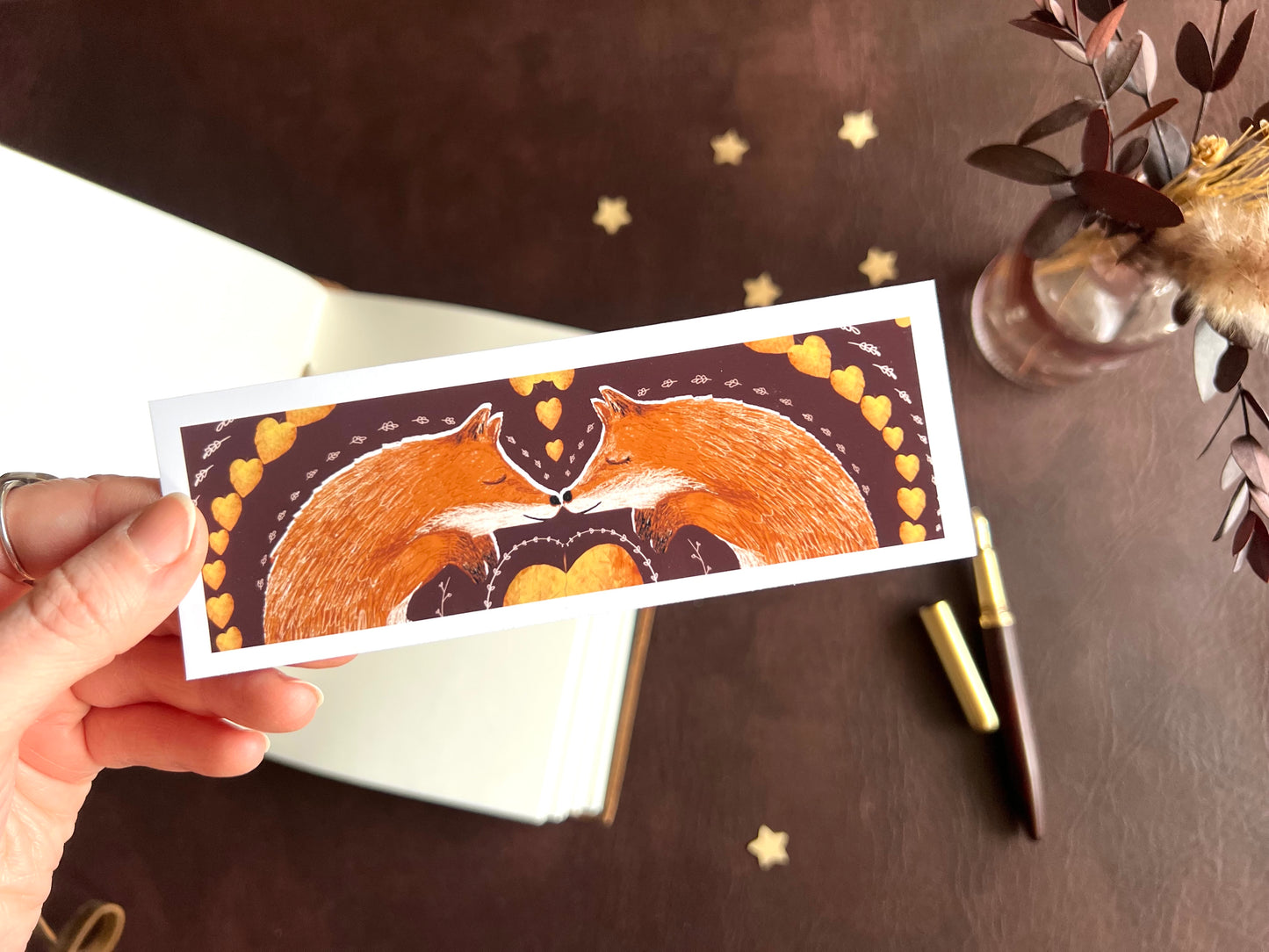 Handcrafted bookmark with storybook illustration of two red foxes. Woodland design.