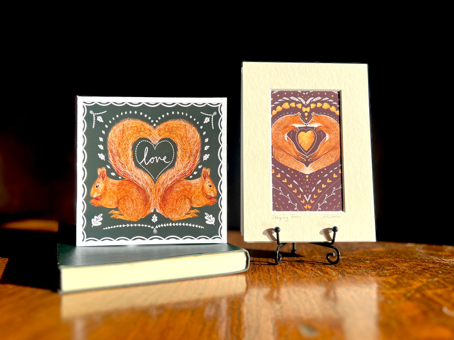 Wedding card and gift set featuring a red squirrel greeting card and a small mounted art print of two foxes nose to nose curled around a heart-shaped autumn leaf. Handmade whimsical illustrations, ideal for woodland, rustic, or whimsical weddings.