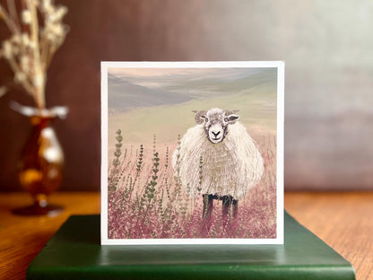 Special illustrated art greeting card featuring a Swaledale sheep standing in a heather landscape on the Yorkshire moors, displayed standing on a leatherette book. Versatile countryside wildlife design with no text on the front, suitable for all occasions.