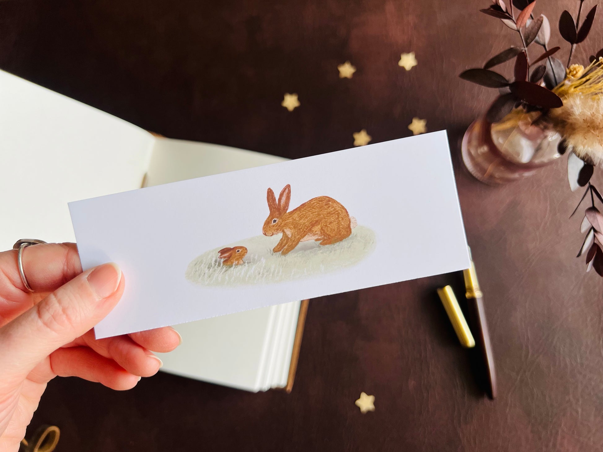 Artisan bookmark handcrafted in East Yorkshire. White bookmark with illustration in the centre. Rabbit and baby rabbit design for stationery lovers. Reading gift or stocking filler gift by UK indie business.