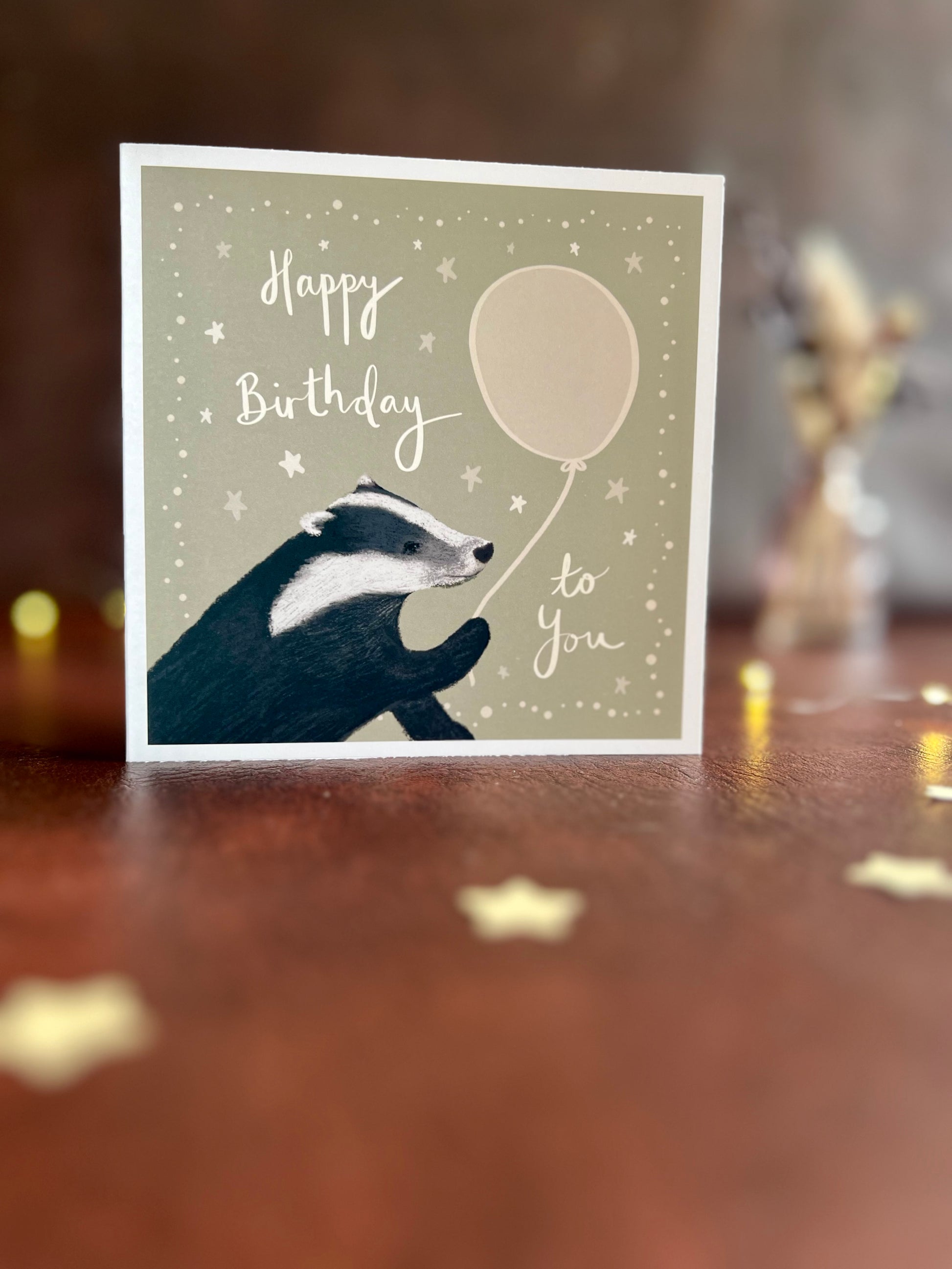 Standard version of illustrated badger birthday card displayed on tabletop, available to order on premium thick luxury cardstock or standard smooth card