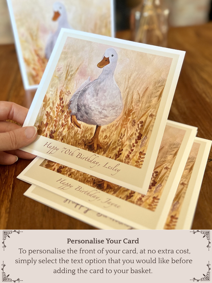 Stack of Duck in the Meadow birthday cards showing different front text designs, top card held slightly forward, with instructions to personalise your card at no extra cost