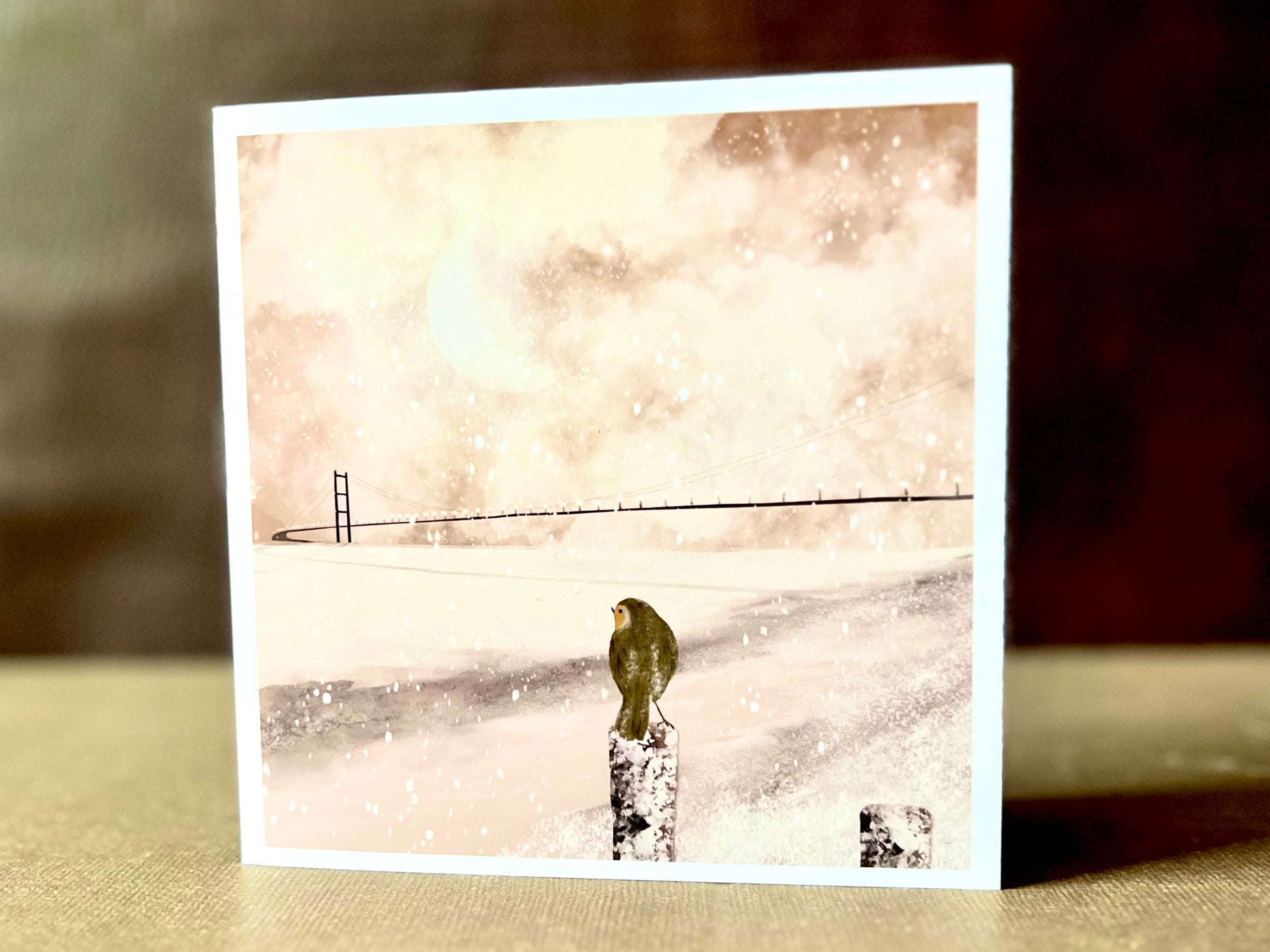 Robin and Humber Bridge greeting card displayed upright, showing a winter scene over the River Humber. Blank inside and suitable for letters or seasonal greetings.