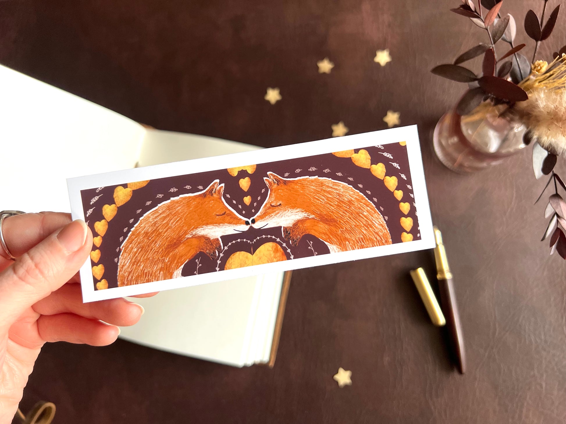 Handcrafted bookmark with storybook illustration of two red foxes. Woodland design. 