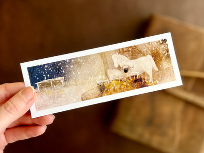 A beautiful bookmark featuring an illustration of a white horse and two sheet on a snowy winter’s night. Artisan gift for reading lovers, stationery lovers and lovers of small pieces of art.