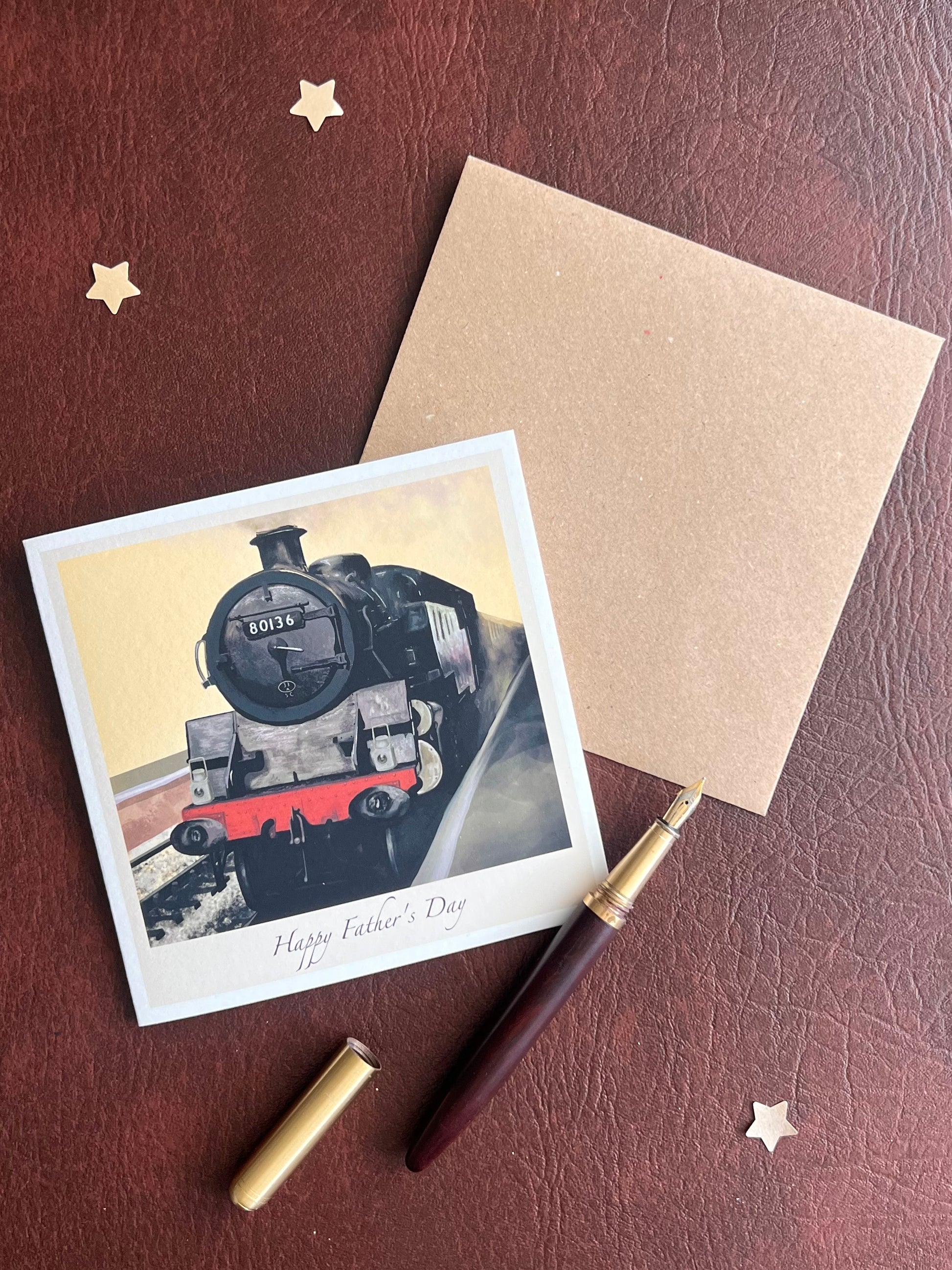 Illustrated North Yorkshire Moors Railway card featuring steam locomotive 80136, photographed flat with its accompanying kraft envelope. Ideal for Father’s Day and special family occasions.