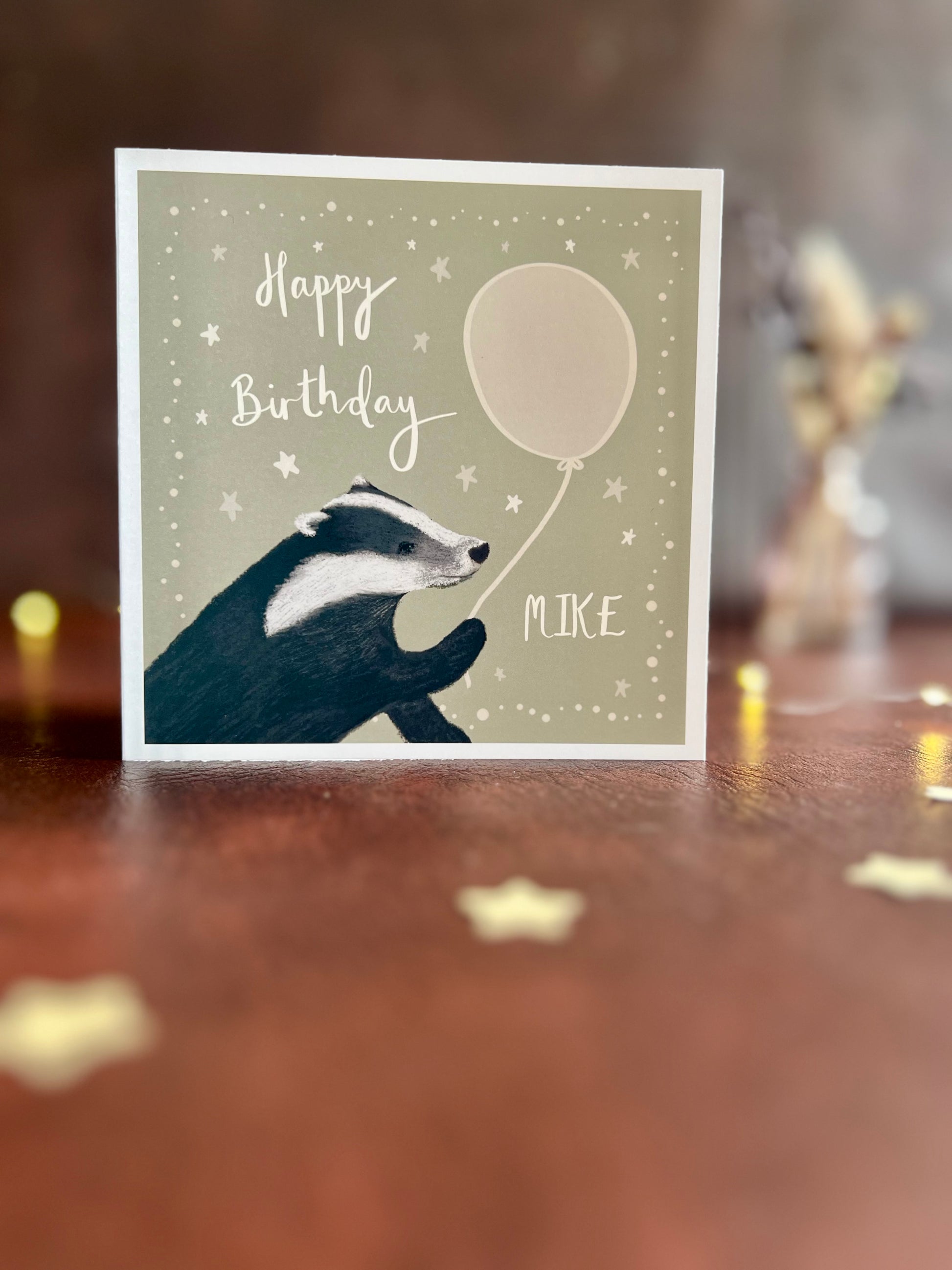 Personalised birthday card with custom name and illustrated woodland animal design, standing on rustic tabletop with dried flowers, ideal for birthday cards for friends, family and loved ones