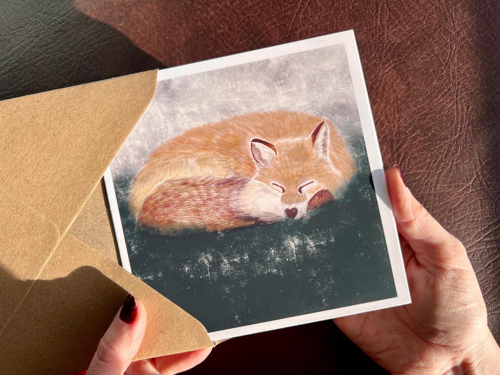 Premium illustrated art card featuring a sleeping fox in a calm woodland scene, set against a textured dark green and grey background. Versatile greeting card suitable for any occasion, showcasing peaceful wildlife illustration and fine art design.