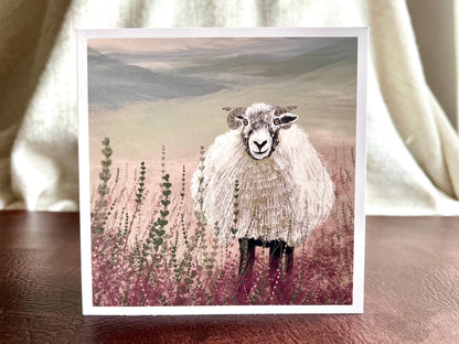 Premium illustrated art greeting card featuring a Swaledale sheep standing in a heather landscape on the Yorkshire moors, displayed standing upright on a tabletop. Versatile countryside wildlife design with no text on the front, suitable for all occasions.