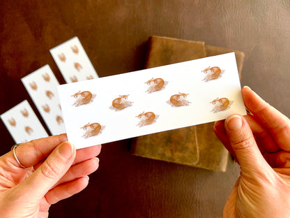 Fox pattern bookmark by artist Hayley Victoria. Artisan bookmark for reading lovers, or to be used as a small stocking filler gift. White background with writers pattern of a happy little fox.