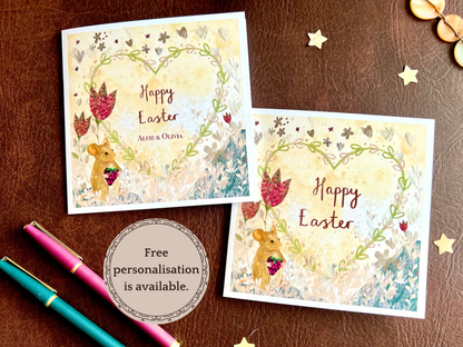 Infographic showing two artisan Easter card design variations featuring an illustrated mouse holding a blackberry with red collage style flowers and a floral heart on a lemon yellow background. One version reads 'Happy Easter' and the other shows 'Happy Easter' with two custom names, with a text box stating 'Free personalisation available'.
