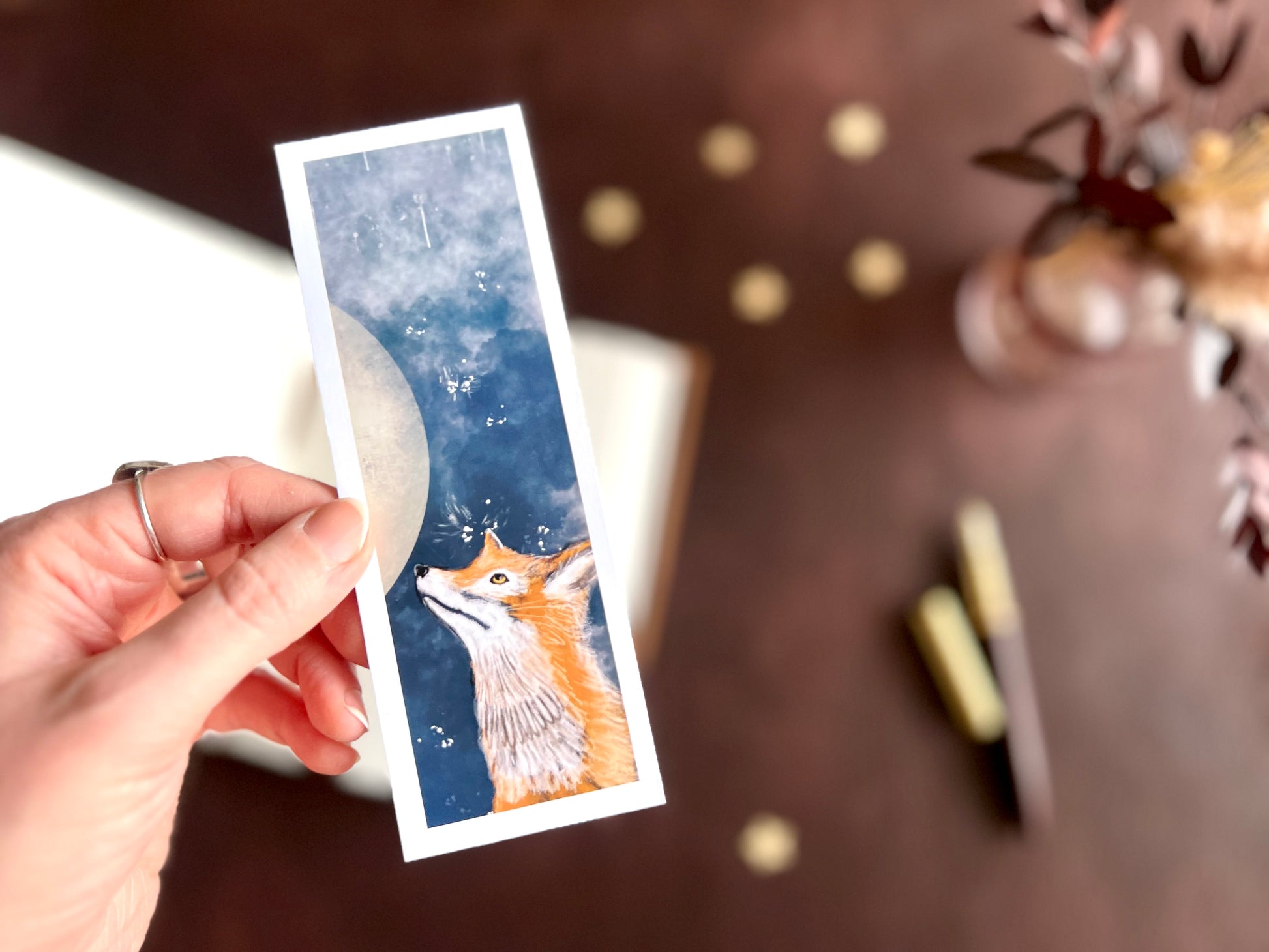 Illustrative artwork on bookmark. Celestial night sky with moon and stars.