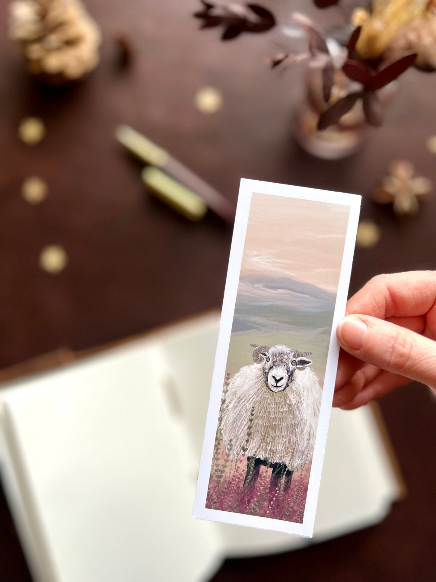 Artisan bookmark handcrafted in East Yorkshire. Woolly sheep design set against purple lavender and heather countryside landscape. 