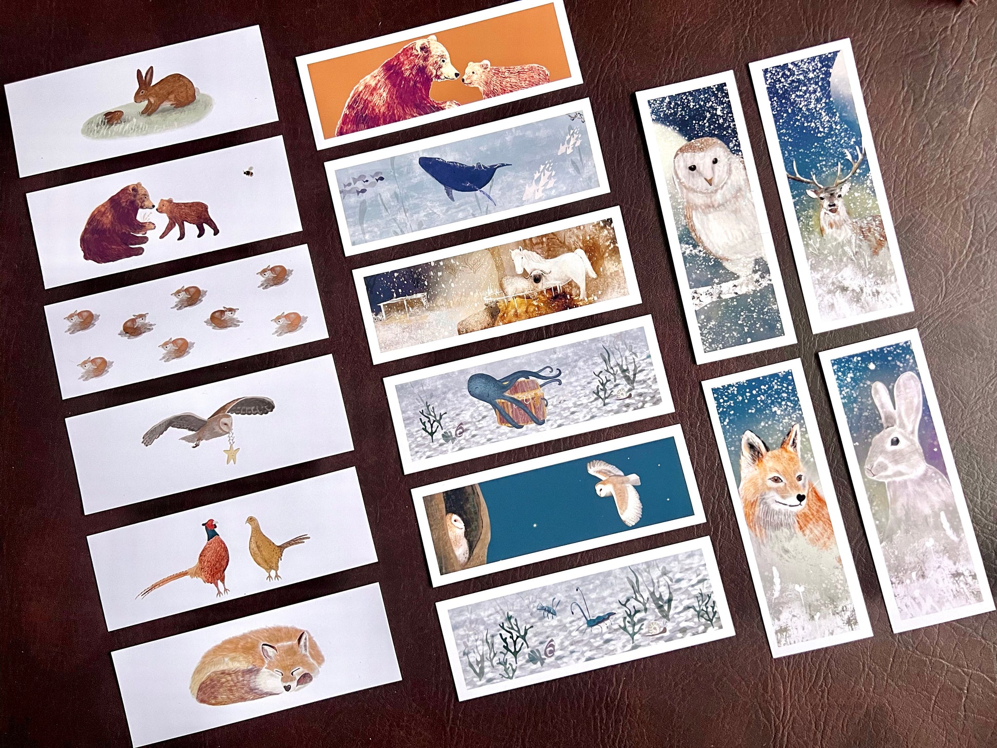Full set of 16 illustrated animal bookmarks displayed on brown background, including woodland and ocean designs, ideal for wedding favours or book lovers.